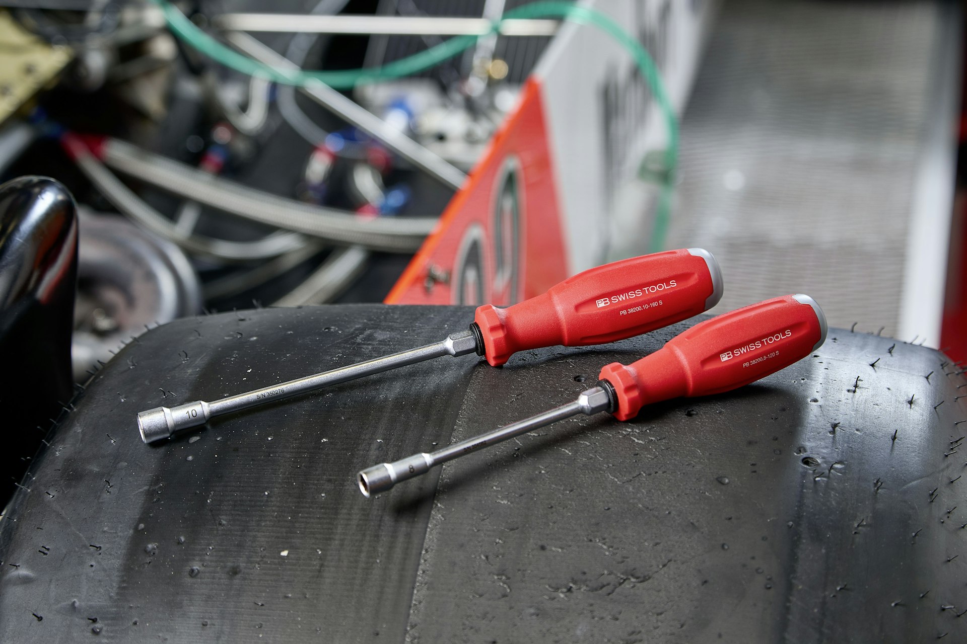 Red wrench in a mechanic's hand